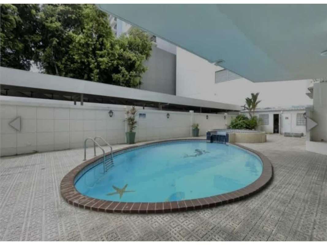 Outdoor swimming pool with jacuzzi and deck area in Panama condo San Francisco