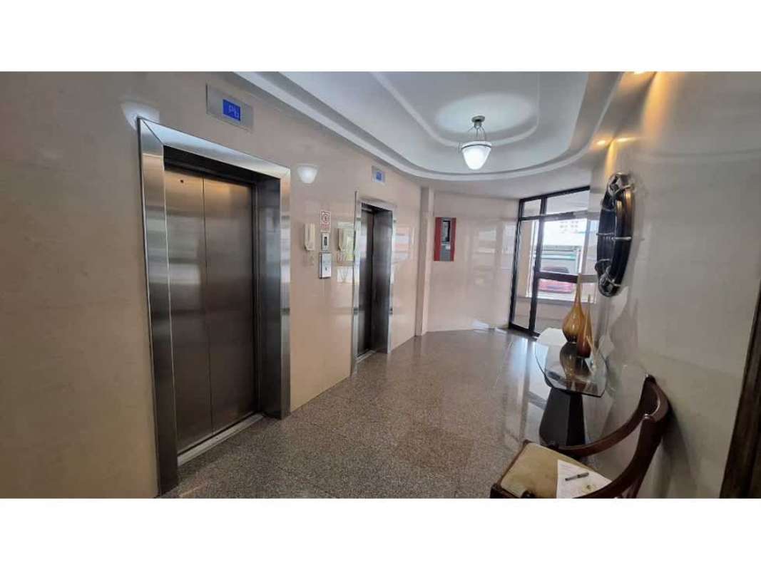 Lobby with two elevators, marble floors, seating area in Panama condominium