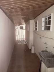 Covered narrow laundry or utility corridor with outdoor sink and tiles La Chorrera house Panama
