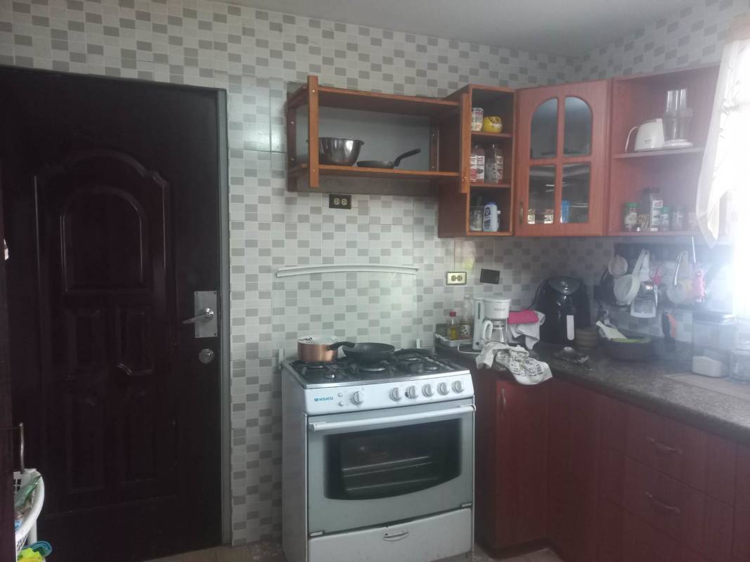 Bright living room with tile floors, ceiling fan, and large windows Panama City house for sale