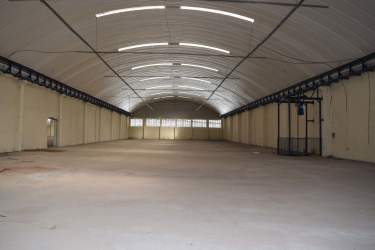 Empty warehouse interior with arched metal roof and open concrete floor Cocosolito Zone Free Colon Panama