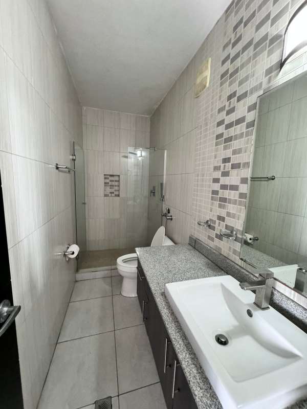 Modern bathroom with glass shower enclosure and granite vanity PH Luxor 200 Obarrio Panama City