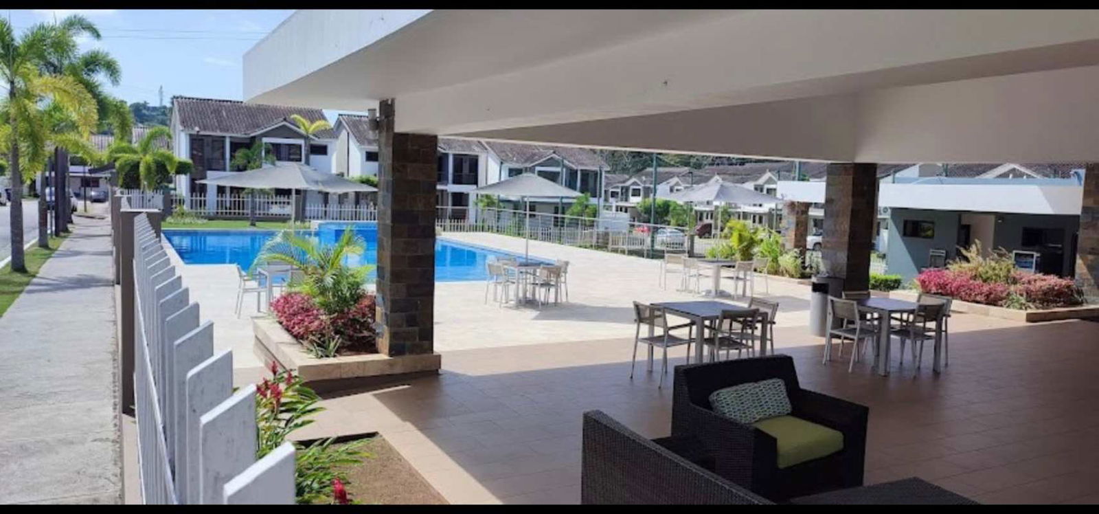 Outdoor swimming pool with lounge chairs inside Mont Blanc residential complex Panama