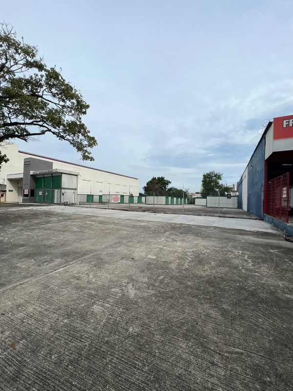 Street view of paved commercial lot with service station building in Rio Abajo Panama City