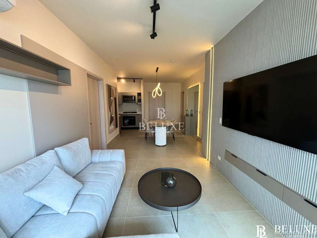 Living room with open kitchen, modern furnishings, panoramic window Ocean House Panama City