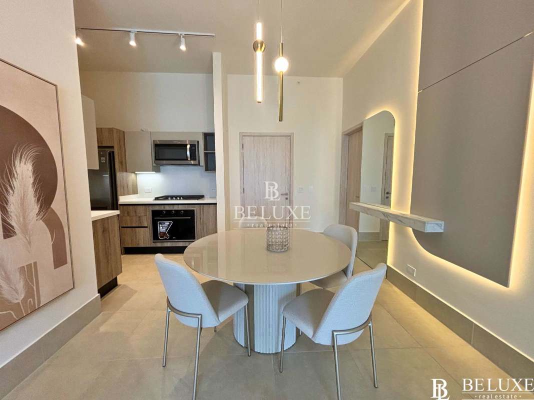 Open plan modern kitchen with dining space in luxury apartment for rent at PH Ocean House Santa María