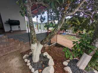 Large bedroom with tiled floor and private bathroom in Burunga house