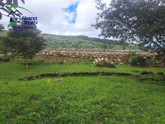 Grassy land with mountain views and some scattered rocks near Boquete Panama