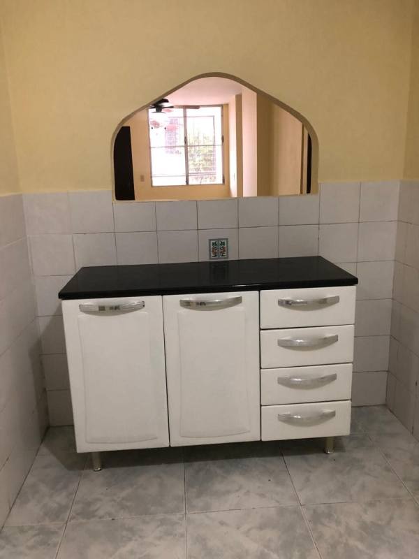 Open serving hatch in kitchen with black countertop in PH Gamma Real Betania Panama City