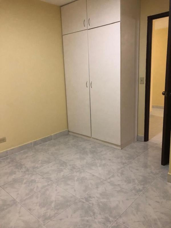 Kitchen area featuring white cabinets, black countertop and double sink at PH Gamma Real in Betania