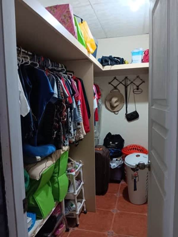 Bedroom with closet and AC window unit traditional home San Antonio Panama