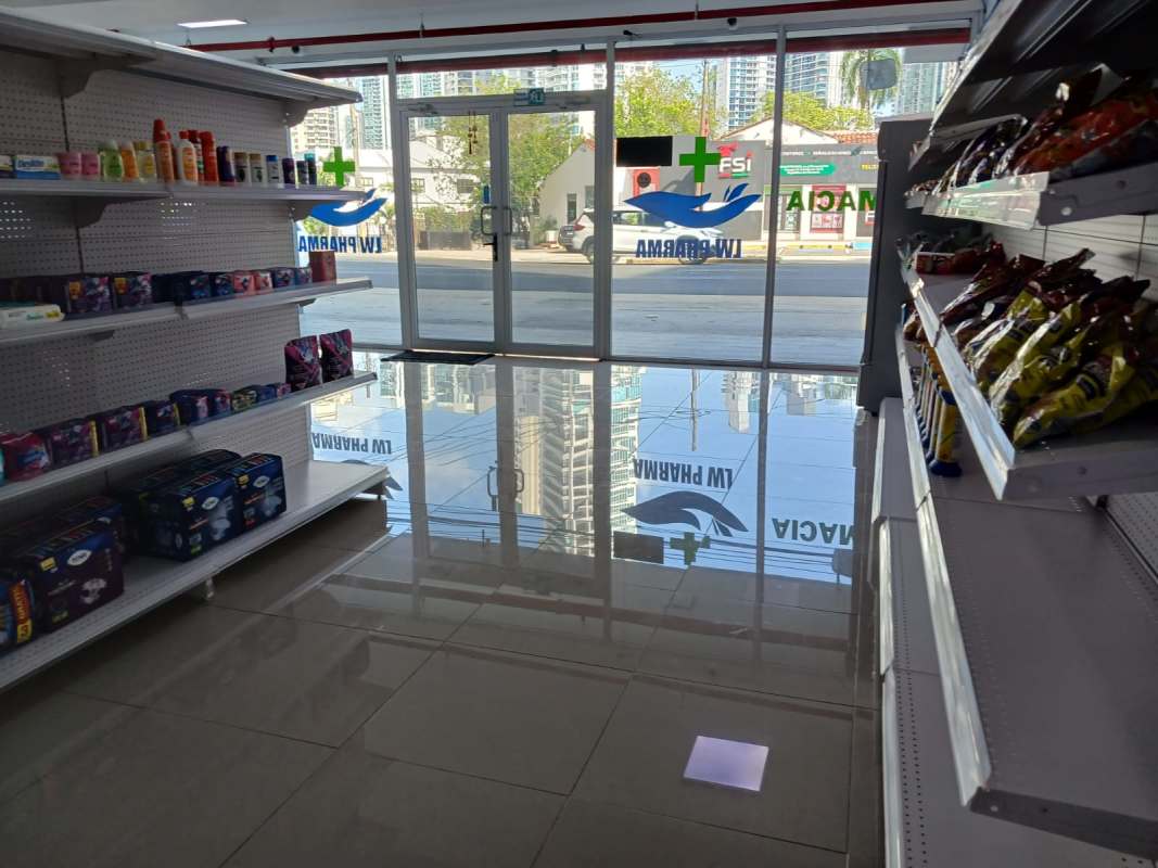 Bright pharmacy interior shelves glass door retail space Signature Point Panama