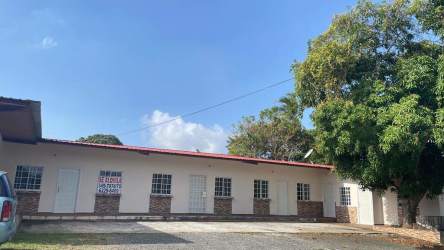 One-story white multi-unit building with red roof and parking La Chorrera Panama