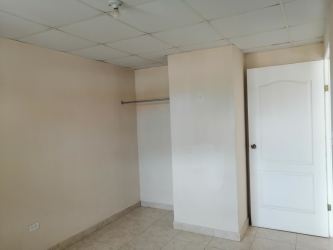Second bedroom tiled floor neutral walls window La Chorrera apartment rent