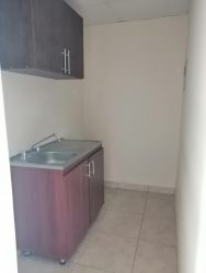 Compact kitchenette with cabinets and stainless sink La Chorrera rental