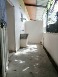 Outdoor laundry zone with utility sink covered roof La Chorrera apartment