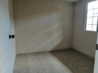 Living room with tiled floors window and white walls La Chorrera apartment for rent