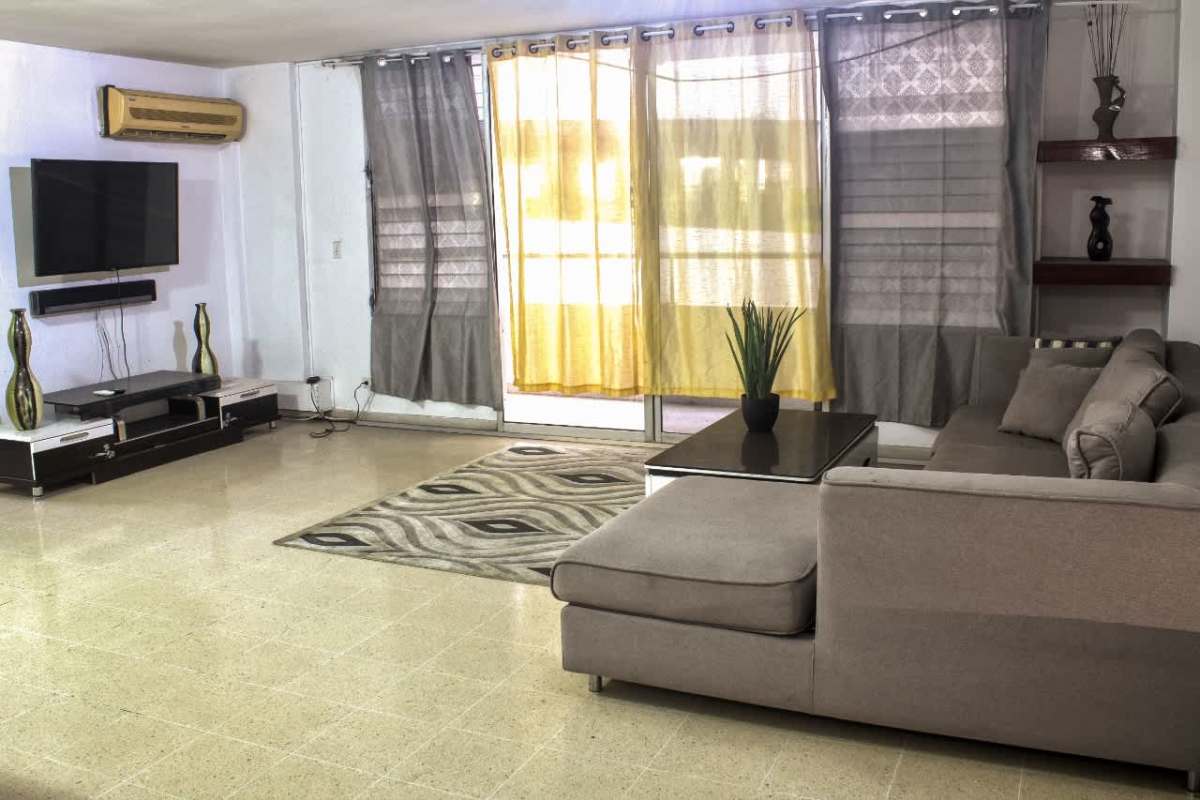 Modern living room with flat screen TV, AC and sectional sofa in PH Del Rey El Cangrejo Panama