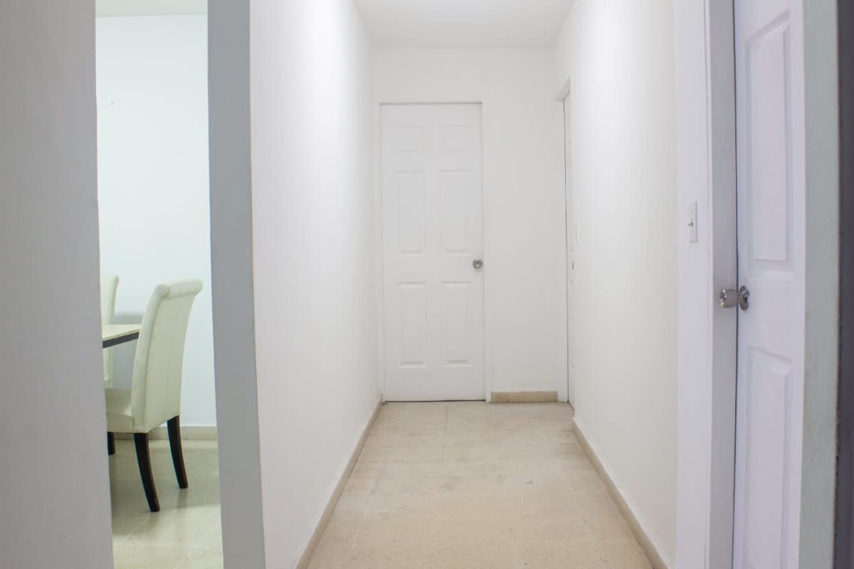 Kitchen with granite countertops, mosaic backsplash, and wood cabinets in PH Del Rey El Cangrejo Panama