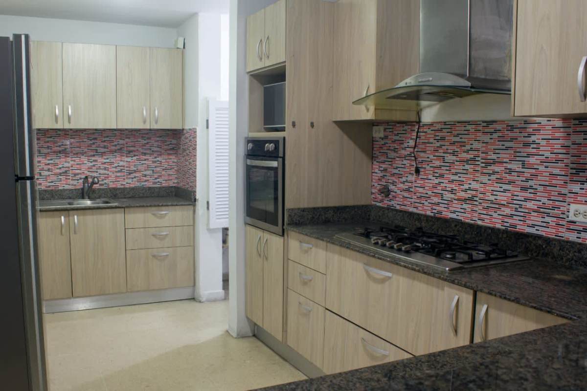 Modern kitchen with mosaic backsplash and granite countertops PH Del Rey Panama apartment