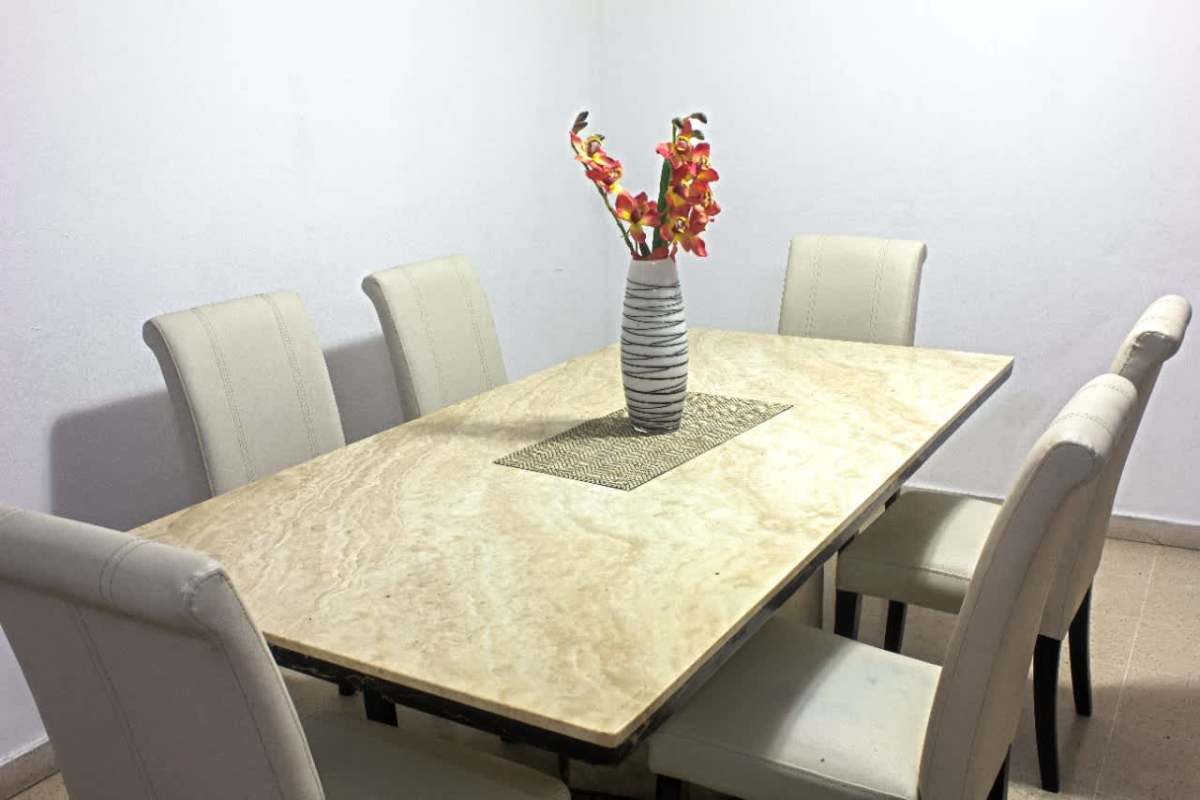 Elegant dining room with marble tabletop and six chairs in PH Del Rey apartment Panama