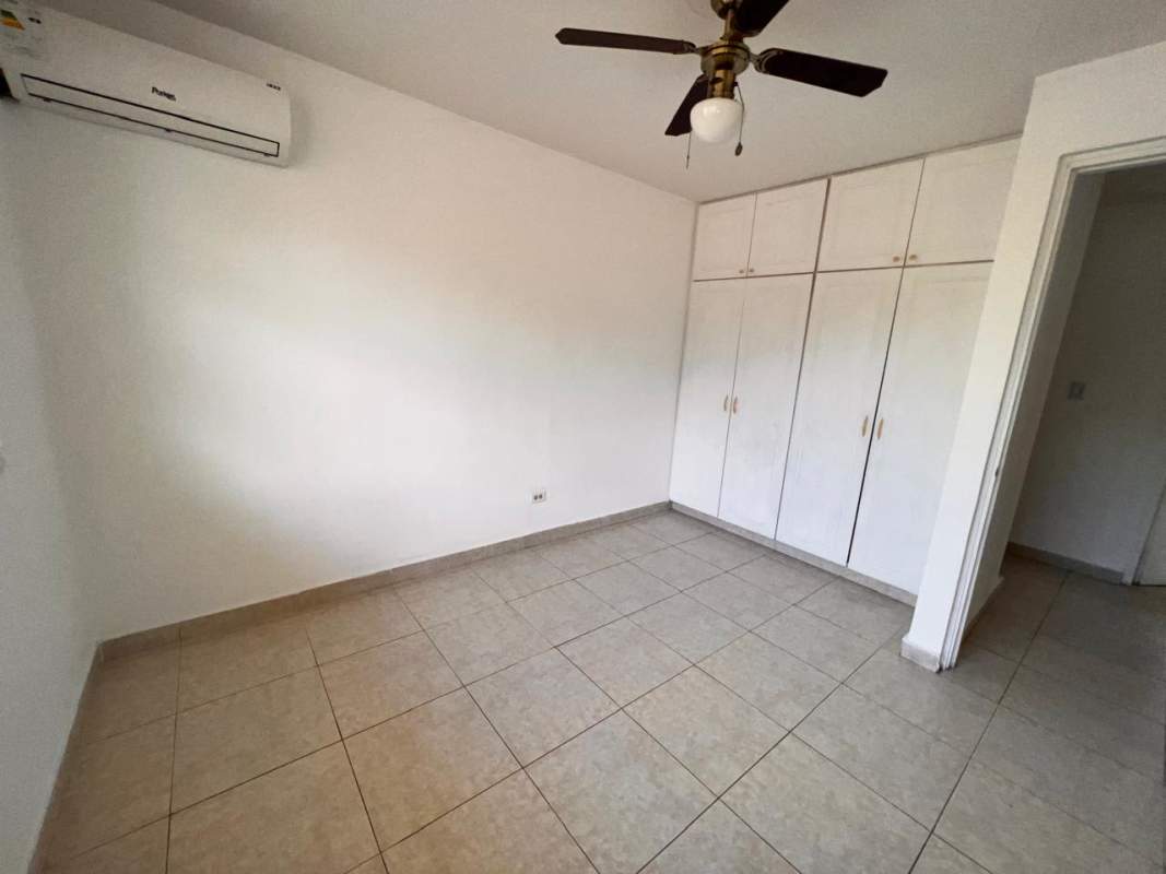 Kitchen with granite countertops and wooden cabinets at Altos de Panamá home for sale