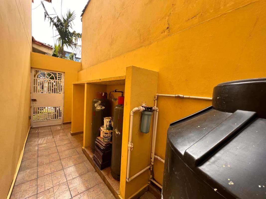 Laundry with double utility sink and yellow walls at Panama City house for sale