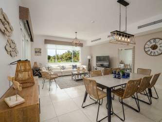 Modern open-concept living dining room furnished with sofa and dining table at Laguna Buenaventura Panama