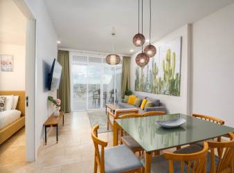 Fully equipped kitchen with island, stainless appliances, and plenty of cabinetry in Marina Village apartment