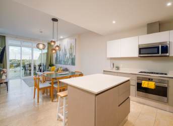 Furnished bedroom with large window, balcony door, and marina view in Marina Village apartment