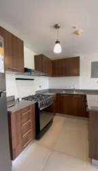 Secondary bedroom with tile flooring and blind shades in PH Midrise apartment