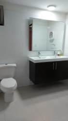 Contemporary bathroom featuring vanity and large mirror at PH Midrise Panama Pacifico