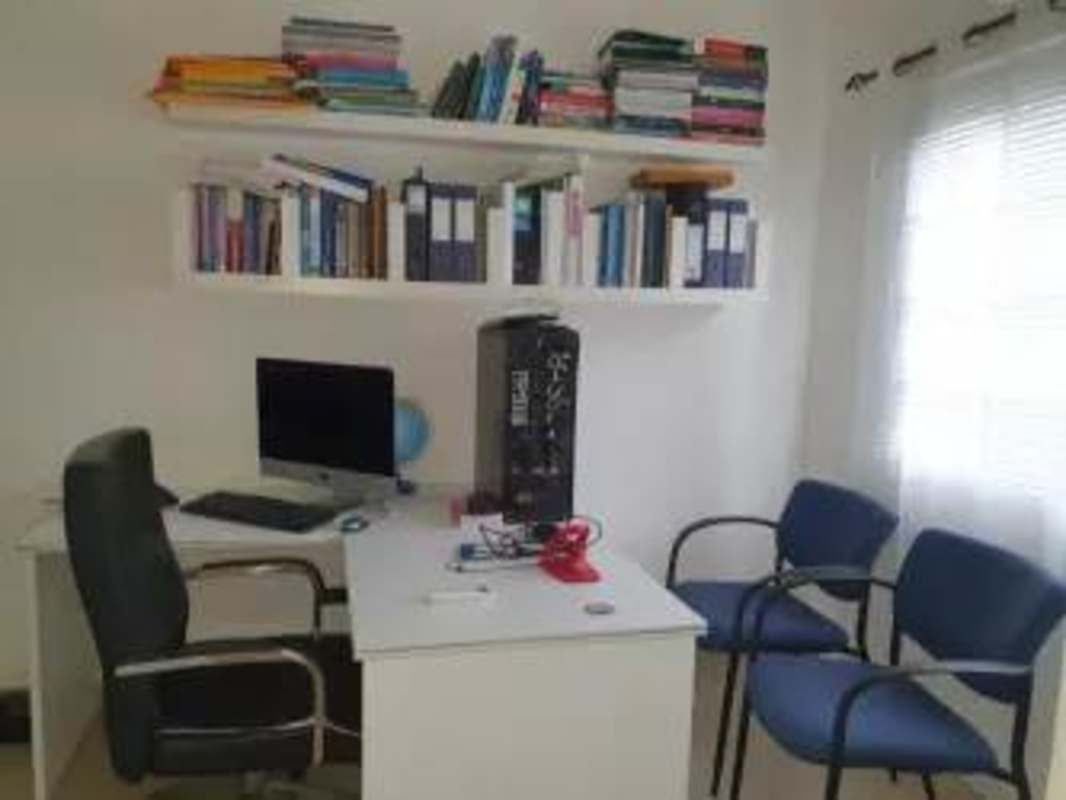 Bright dedicated workspace with windows, desk, bookshelves in family house Cardenas Clayton Panama