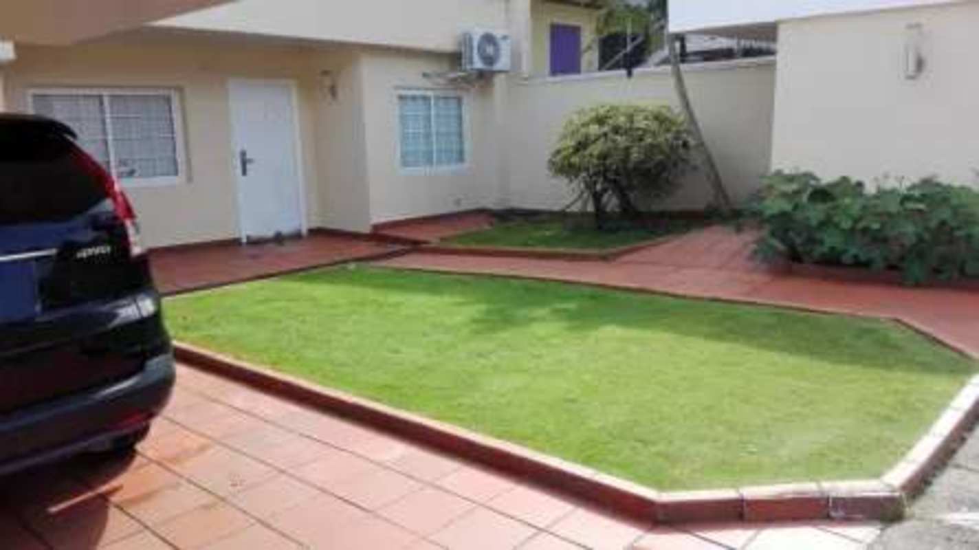 Two-car covered garage with greenery and driveway Cardenas Panama