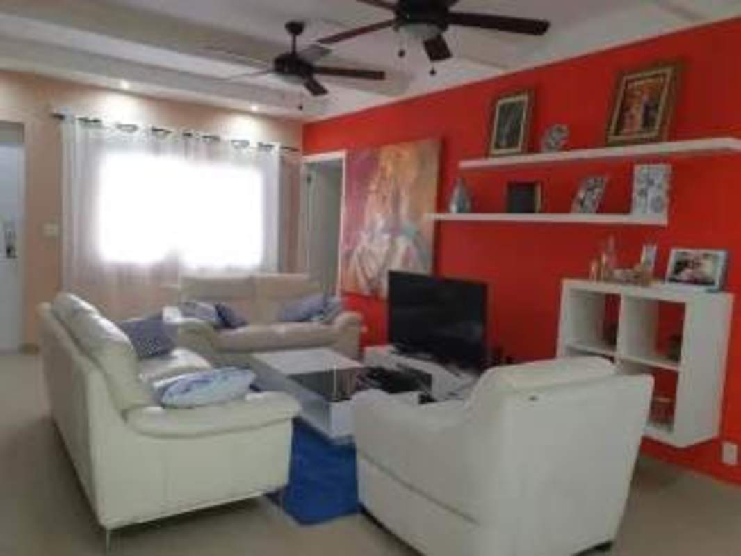 Dining room adjacent to modern kitchen with breakfast bar in family home Cardenas Panama City