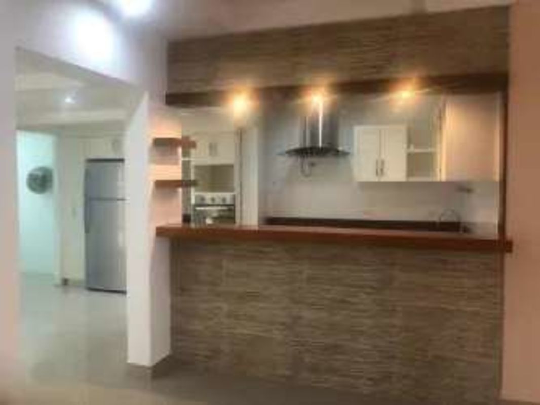 Contemporary living room with accent wall, comfortable sofas, and TV in family house Cardenas Clayton Panama