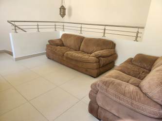 Modern bathroom with glass shower enclosure, porcelain sink and tile design River Valley Panama