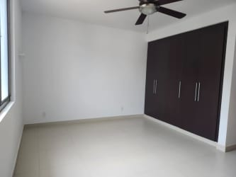 Open living and dining area with porcelain floors and large windows at River Valley house Panama