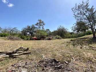 Grassy vacant land with trees inside private Coronado Beach community Panama
