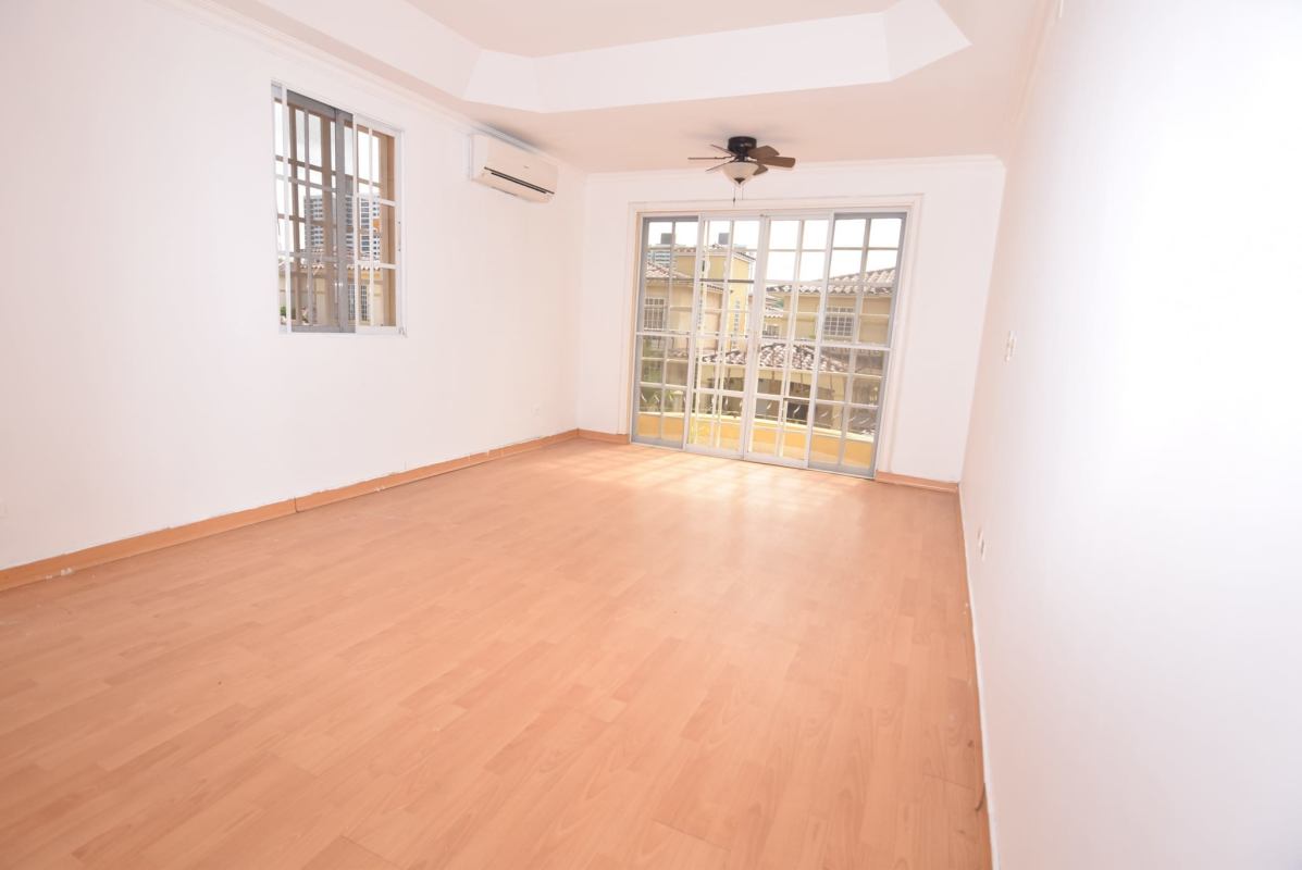 Bright living room with sliding glass doors, ceiling fan, AC and balcony at The Spring Condado del Rey