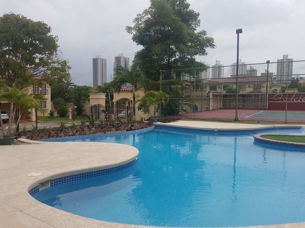 Large entrance foyer with staircase and ceramic tile flooring at The Spring Condado del Rey House