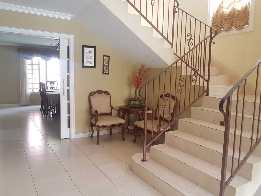 Spacious kitchen with wooden cabinets and granite countertop in The Spring Condado del Rey house