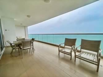 Modern balcony with seating area and panoramic beach view Santa Clara Residences Panama