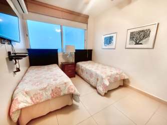 Open-plan living dining connected to balcony, oceanfront views at Santa Clara Residences Panama