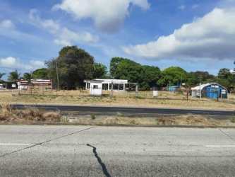 Small existing building on flat land with fence adjacent to Interamericana Highway Bejuco