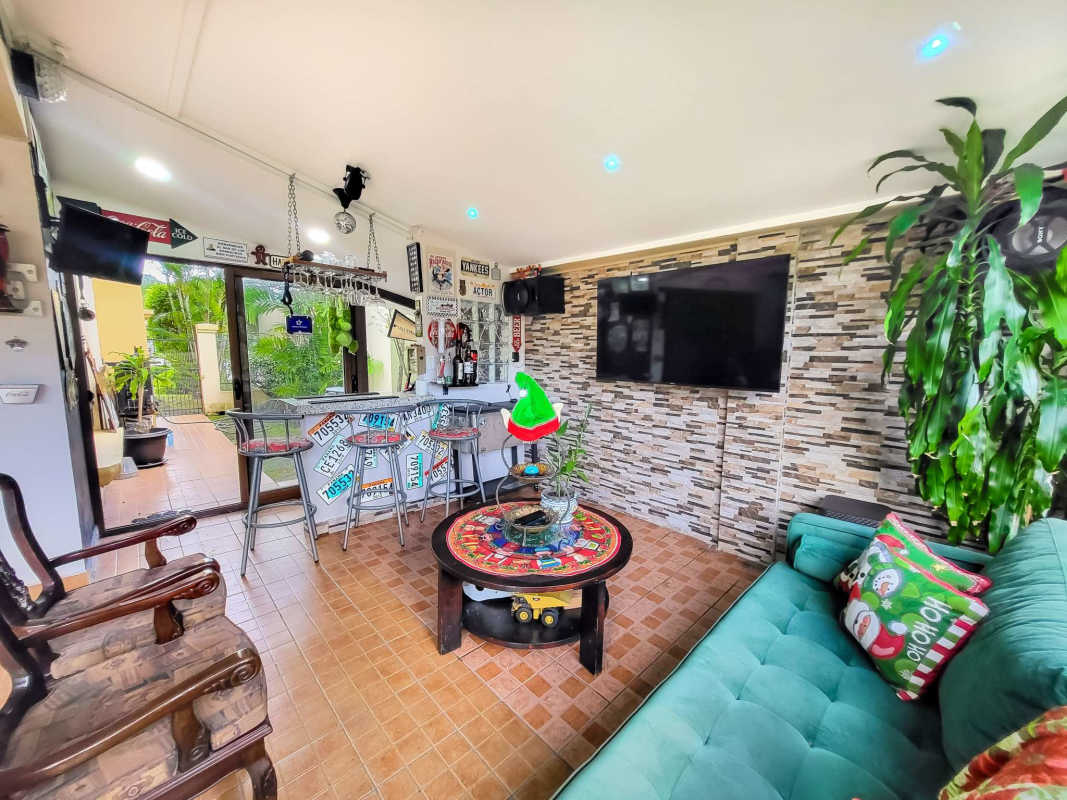 Living room with bar area and holiday decor in Condado del Rey house for sale