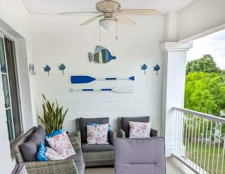 Coastal style balcony with wicker furniture and greenery view PH Howard Bijao Beach Panama