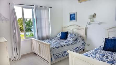 Bedroom with two beds blue and white decor PH Howard Bijao Panama beach resort