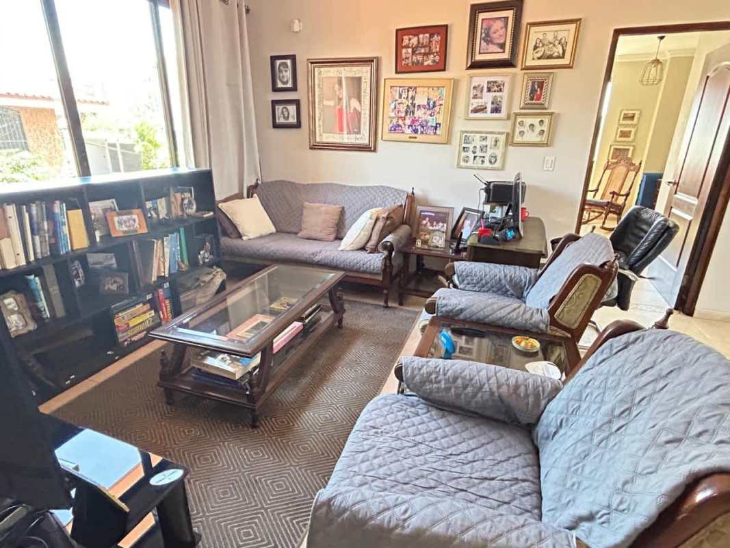 Spacious living room with bay window, traditional decor, large windows in El Carmen Panama