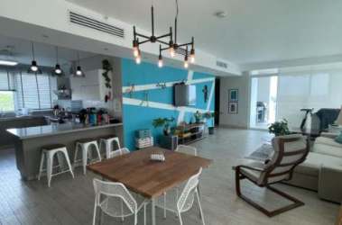 Bright living room with accent wall, contemporary furnishings in Solea Punta Barco